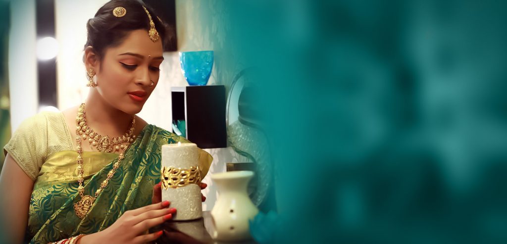 portrait of a bride in traditional green color saree with jewels